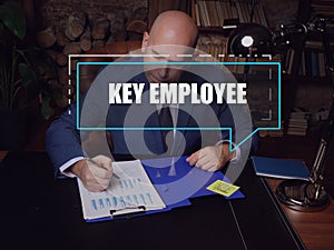 KEY EMPLOYEE text in footnote block. Merchant checking financial report AÃÂ key employeeÃÂ is anÃÂ employeeÃÂ with major ownership photo